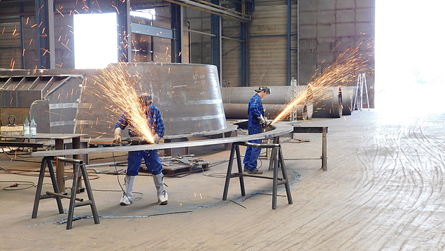 Bild von zwei Mitarbeitenden, die an einem Hilgefort-Behälter schweißen. Funken fliegen.
